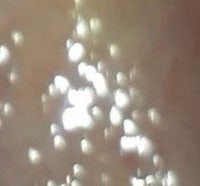 a close up of a person's face with a light shining on it