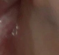 a close up of a woman's mouth with a lot of water in it